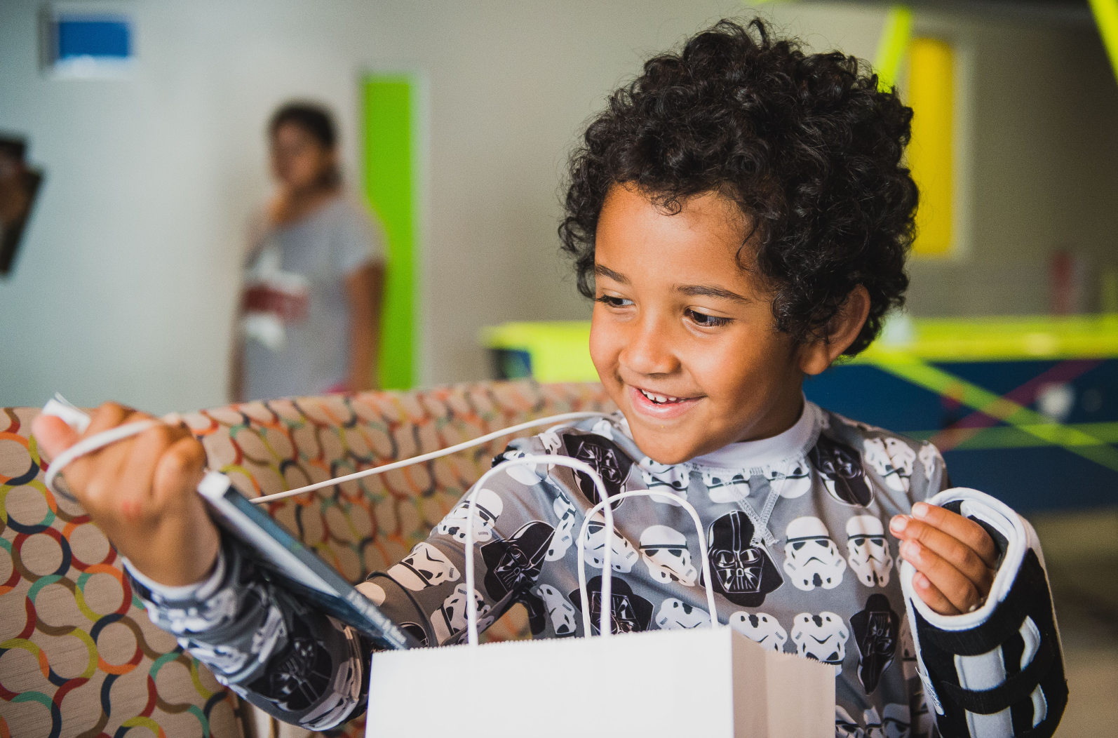 A young patient receiving a comfort gift from GameChanger.