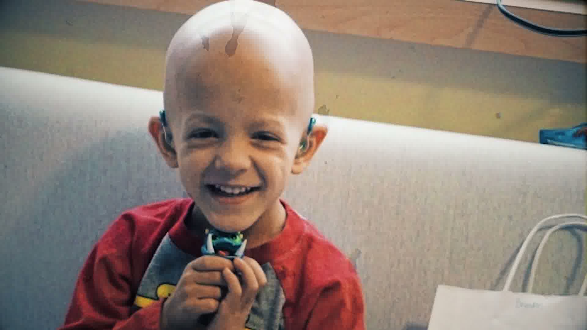 A young patient beaming, mid-treatment.